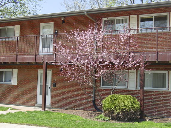 Front view of a two-story brick apartment building.