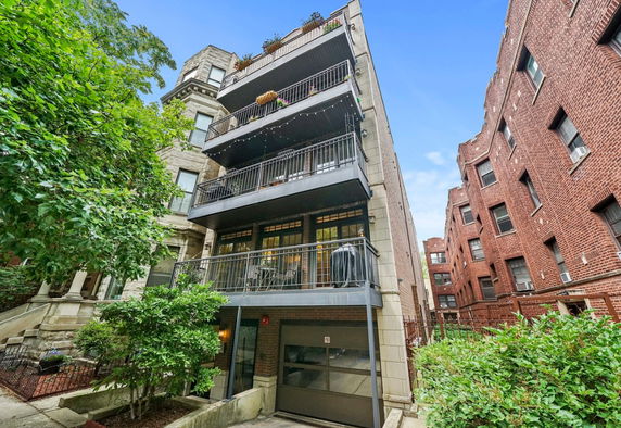 Front view of a multi-story residential building with balconies.