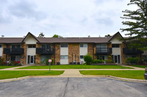 Front view of a two-story residential building with balconies.