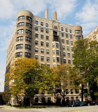 Front view of a multi-story residential building with rounded corners.
