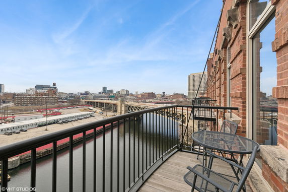 Panoramic view from a balcony overlooking a river and cityscape.