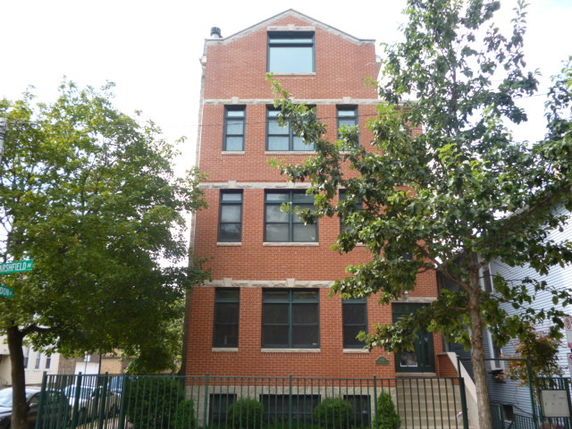 Front view of a multi-story brick building.