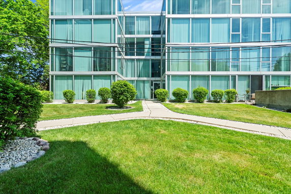 Front view of a modern glass building with large windows.