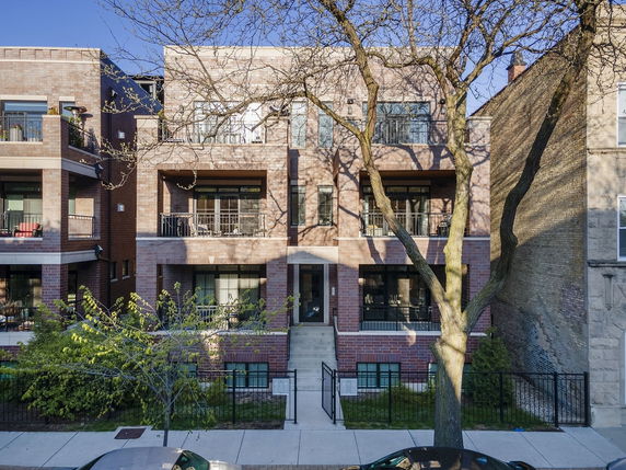 Front view of a multi-story brick apartment building.