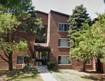 Front view of a three-story brick apartment building.