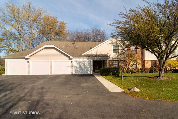 Front view of a house with a three-car garage and a gable roof.