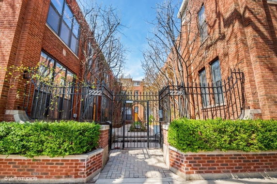 Front view of a brick building with gated entrance.