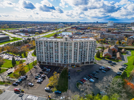 Front view of a mid-rise residential building with balconies.