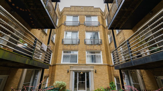 Front view of a multi-story brick apartment building.