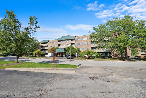 Front view of a multi-story apartment building with balconies.
