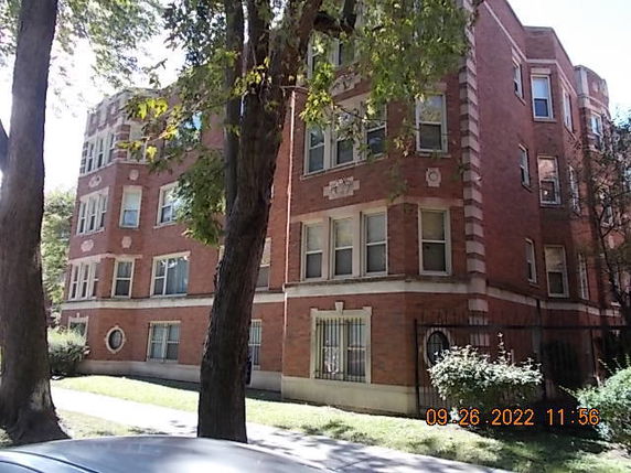 Front view of a multi-story brick apartment building.