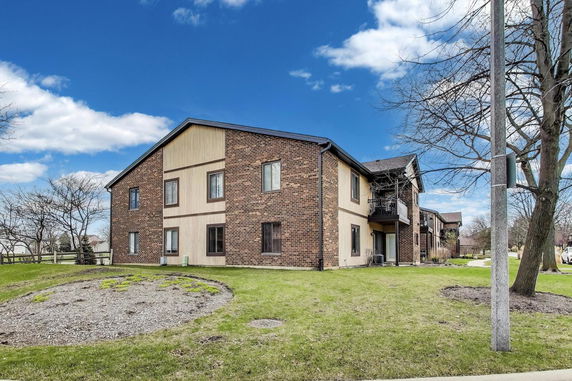 Front view of a two-story brick and siding building.