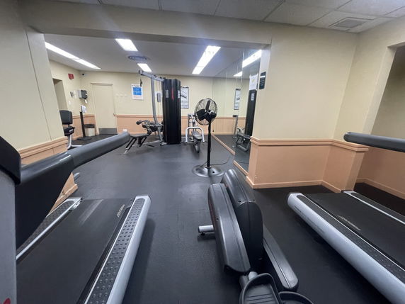 Indoor gym area with treadmills and exercise equipment.