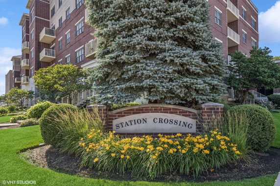Front view of a multi-story brick building with balconies.