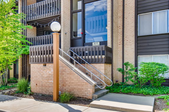 Front view of a building with stairs leading to the entrance.