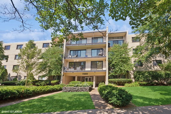 Front view of a multi-story apartment building with balconies.