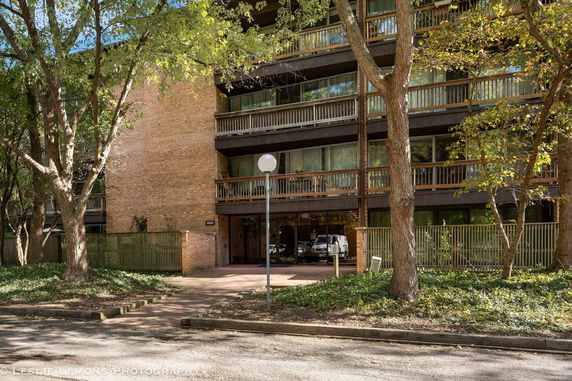 Front view of a multi-story brick building with balconies.