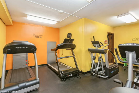 Indoor gym area with treadmills and exercise equipment.