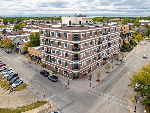 Multi-story brick building on a street corner.