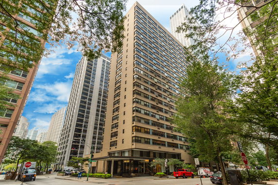 Front view of a tall multi-story apartment building.