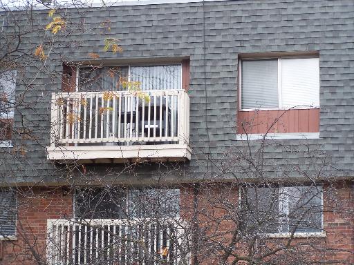 Front view of a multi-story building with balconies.