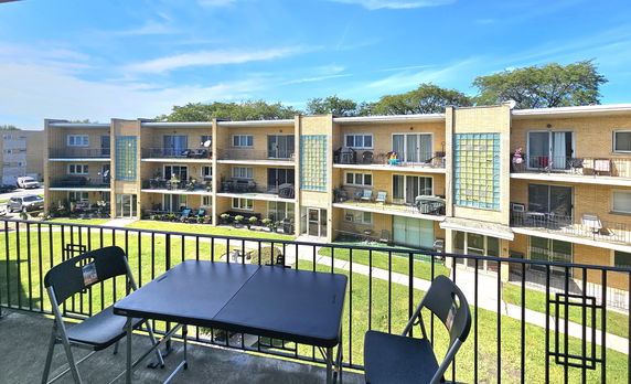 Panoramic view of a multi-story apartment building with balconies.