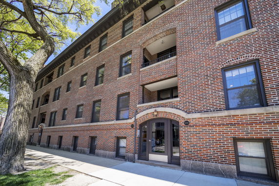 Front view of a multi-story brick apartment building.