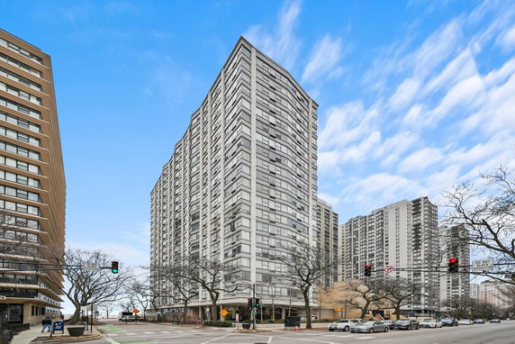 Front view of a high-rise apartment building with multiple windows and balconies.