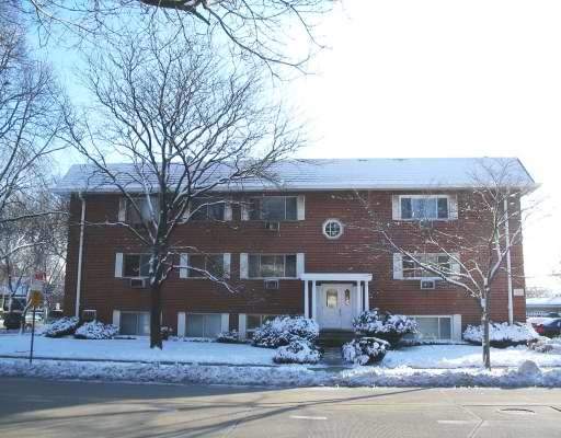 Front view of a two-story building with a gabled roof and snow-covered surroundings.