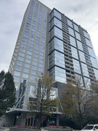Front view of a tall modern apartment building.