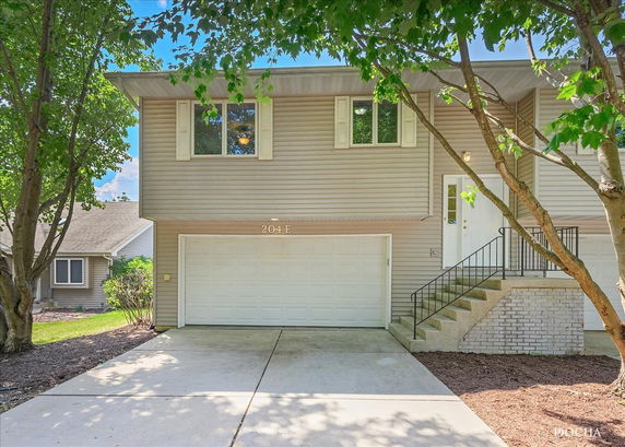 Front view of a two-story house with an attached garage.