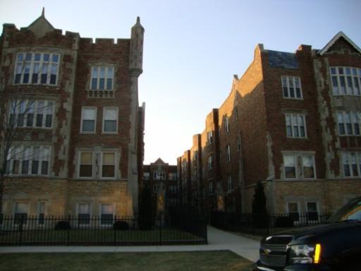 Front view of a multi-story brick building with decorative elements.