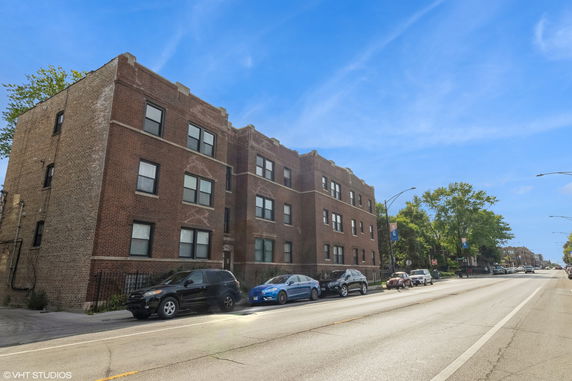 Front view of a three-story brick apartment building.