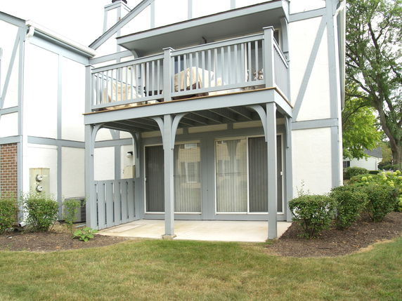 Front view of a two-story building with a balcony.