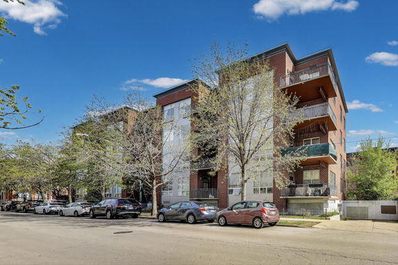 Front view of a multi-story residential building with balconies.