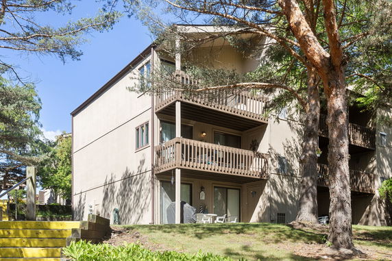 Front view of a multi-story apartment building with balconies.
