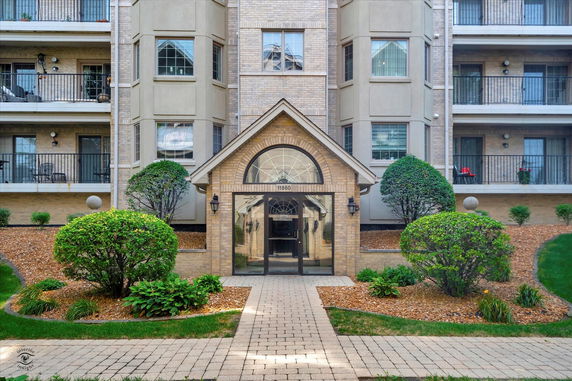 Front view of a multi-story residential building with balconies.