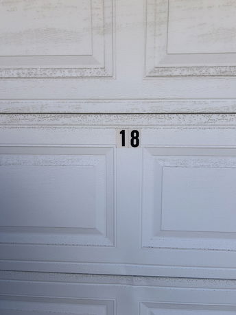 Close-up view of a garage door with the number 18.