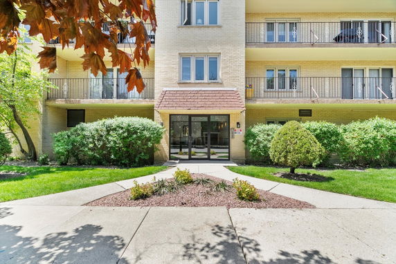 Front view of a multi-story residential building with balconies.