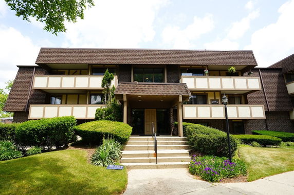 Front view of a multi-story apartment building with balconies.