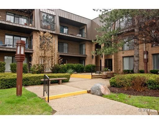 Front view of a multi-story apartment building with balconies.