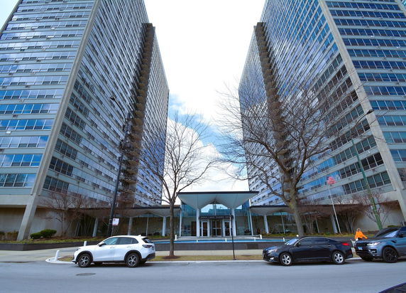 Front view of two tall residential buildings with a shared entrance area.
