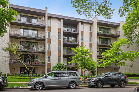 Front view of a multi-story apartment building with balconies.