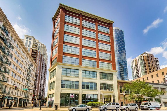 Front view of a multi-story building with large windows.