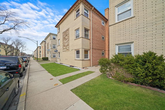 Front view of a brick multi-story residential building.