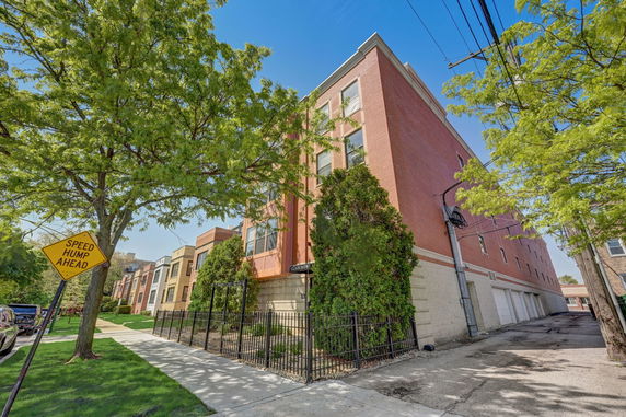 Front view of a multi-story brick residential building.