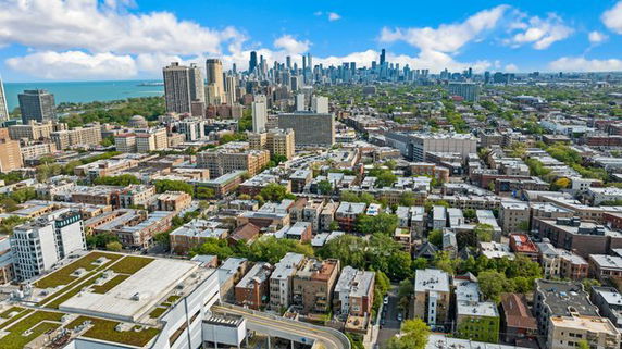 Panoramic view of a cityscape with numerous buildings and a visible skyline.