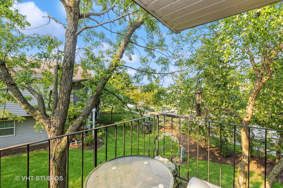 View from a balcony with trees and surrounding area visible.