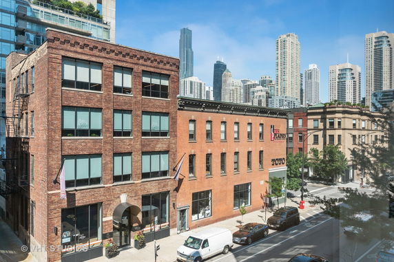 Front view of multi-story brick buildings in an urban setting.