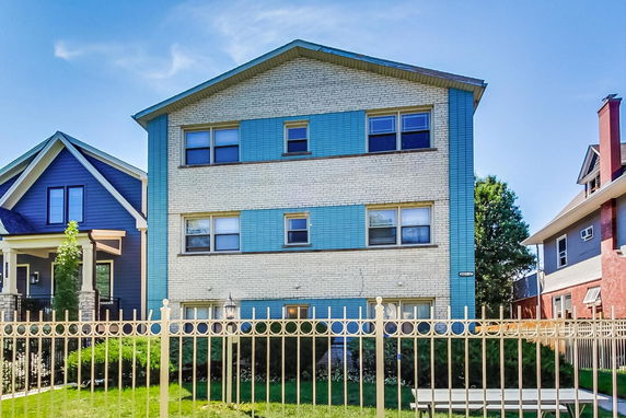 Front view of a multi-story residential building with blue accents.